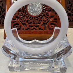 A white ring sitting on top of a glass table.