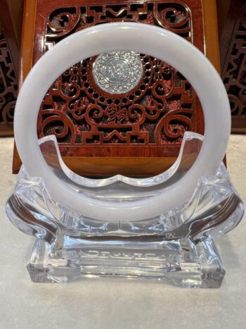 A white ring sitting on top of a glass table.