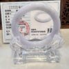 A white ring sitting on top of a clear glass holder.