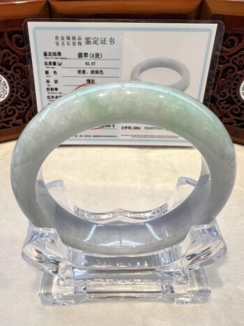 A green jade bangle sitting on top of a table.