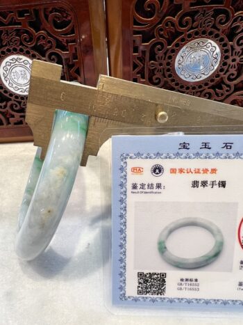 A pair of green jade bracelets are on display.