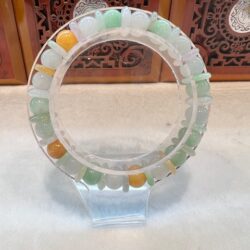 A glass ring with many different colored stones.