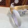 A white marble bowl sitting on top of a table.