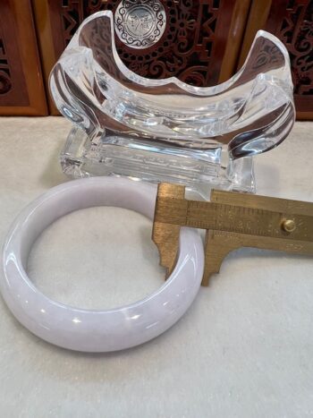 A white bangle sitting on top of a table.