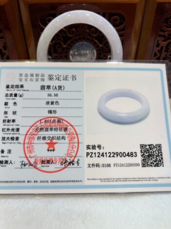 A white ring is sitting on top of a certificate.