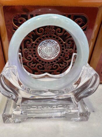 A white plate sitting on top of a clear glass table.