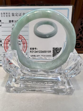 A glass ring sitting on top of a clear glass holder.