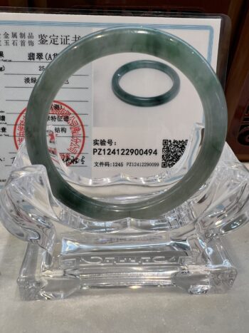 A glass stand with a green ring on it