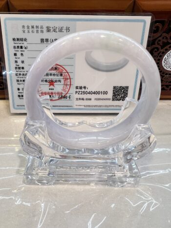 Jade bangle on stand with certification.