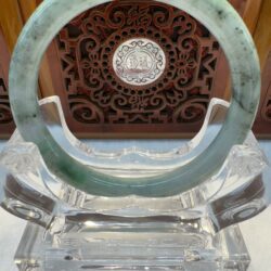Light green jade circle on crystal stand
