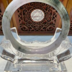 Translucent lavender jade bangle on clear stand