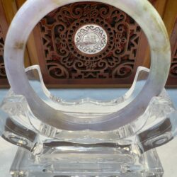Translucent pale jade bangle on clear stand