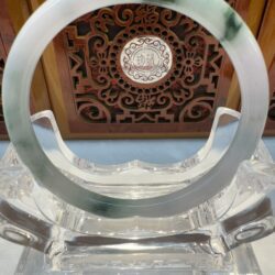Crystal display with jade circular ornament.