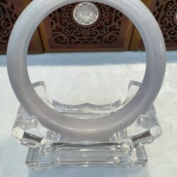 Translucent bangle displayed on a stand.