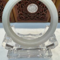 Translucent jade circle resting on clear base