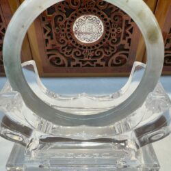Centered translucent jade bangle and decorative panel