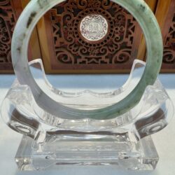 Two-tone jade bangle with dark inclusions