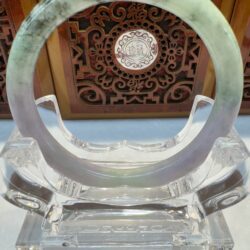 Translucent jade bangle on acrylic stand