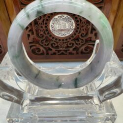 Polished green-veined jade bracelet display