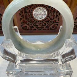 Circular jade hoop with wooden carved medallion
