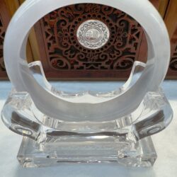 Crystal display stand with circular design.