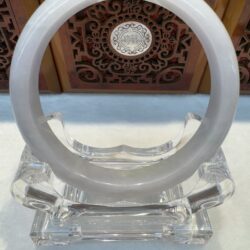 White circular ring on ornate stand display.