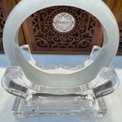 Translucent circular object on ornate wooden background.