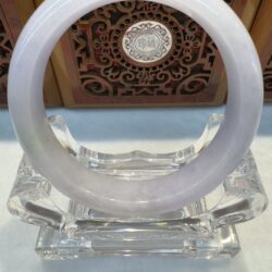 Elegant white jade bracelet on clear pedestal