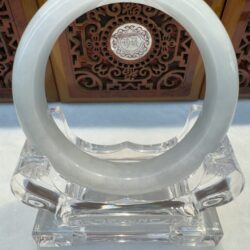 Smooth pale jade bracelet on clear stand