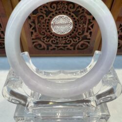 Pale lavender jade bangle on clear stand