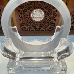 Circular jade disk centered over ornate panel