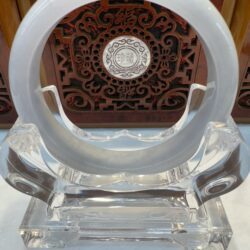 Milky white jade bangle on crystal display