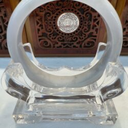 White jade bangle on acrylic stand
