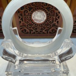 Smooth white jade circle displayed upright