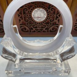 White circular object on ornate wooden background.