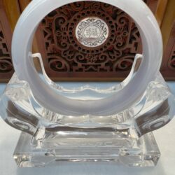 Smooth white jade bangle on acrylic stand