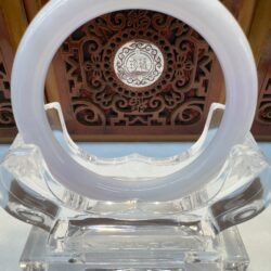 Circular ornament on a decorative stand.