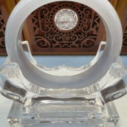 Circular milky jade bangle on acrylic holder