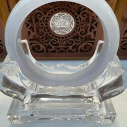 Translucent white jade bracelet on acrylic display