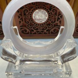 Round white jade bracelet on crystal cradle