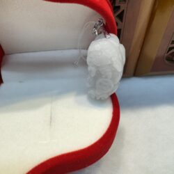 White jade pendant in red velvet box.