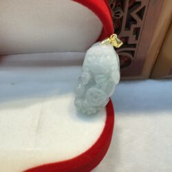 Jade pendant in red velvet-lined box.