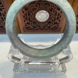 Translucent pale jade bracelet with carved background