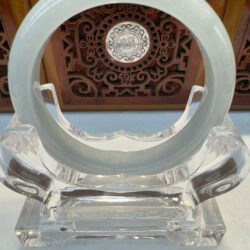 Translucent milky jade bracelet on display stand