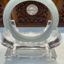 Circular green jade ring on acrylic holder