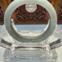 Jade bangle on decorative stand display.