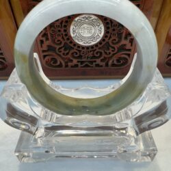 Translucent pale jade bangle displayed upright