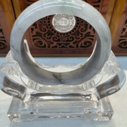 Gray veined jade bangle on lucite stand