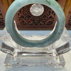 Round jade bangle with carved backdrop