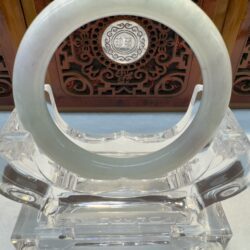Milky white jade bangle on clear display